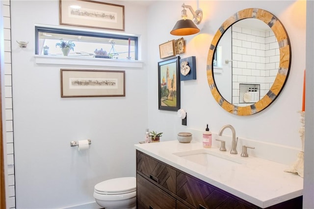 bathroom featuring vanity and toilet