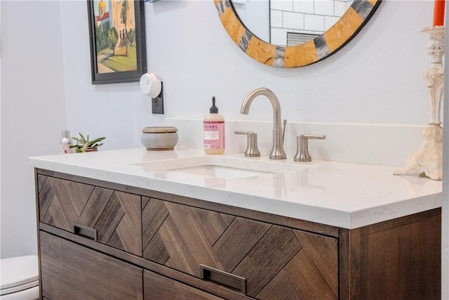 bathroom featuring vanity and toilet