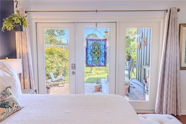 bedroom with multiple windows, access to outside, and french doors