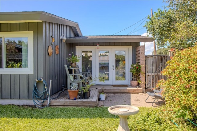 doorway to property featuring a yard and french doors