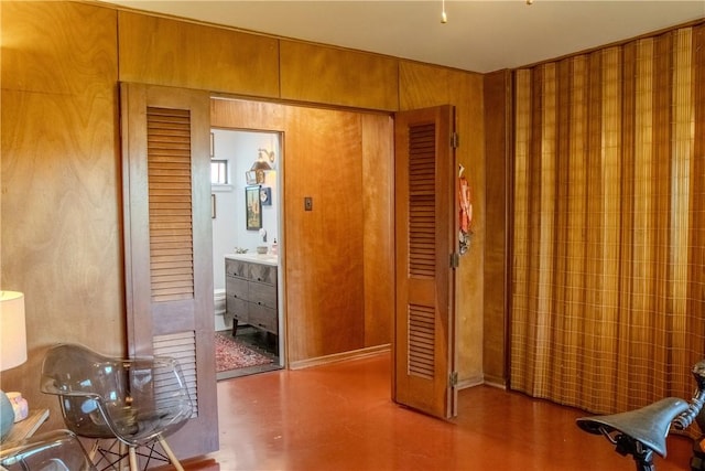 interior space featuring ensuite bath and wooden walls