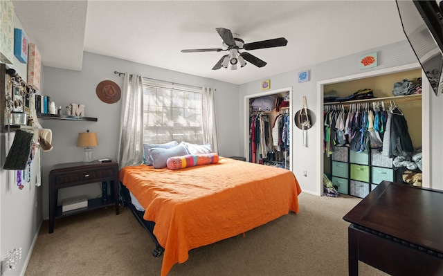 bedroom featuring two closets, ceiling fan, and carpet floors