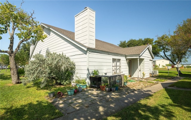 back of property featuring a lawn and a patio area