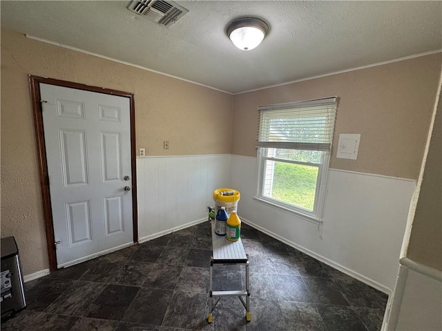 1222 Nancy St, Corpus Christi, TX 78412 - dining area featuring a textured ceiling, a wainscoted wall, ornamental molding, and a textured wall