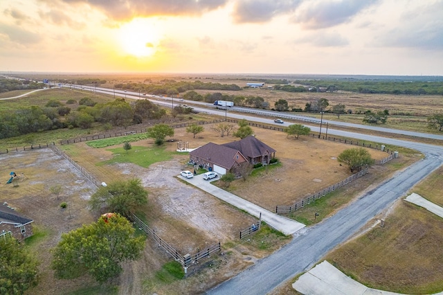 aerial view at dusk featuring a rural view