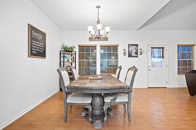 dining space with a chandelier and light hardwood / wood-style flooring