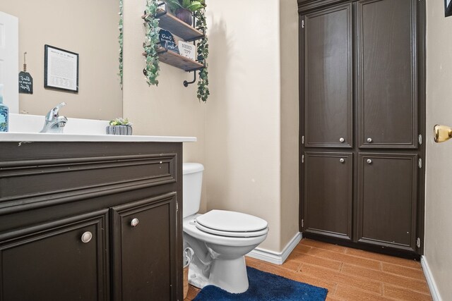 bathroom with toilet and wood-type flooring