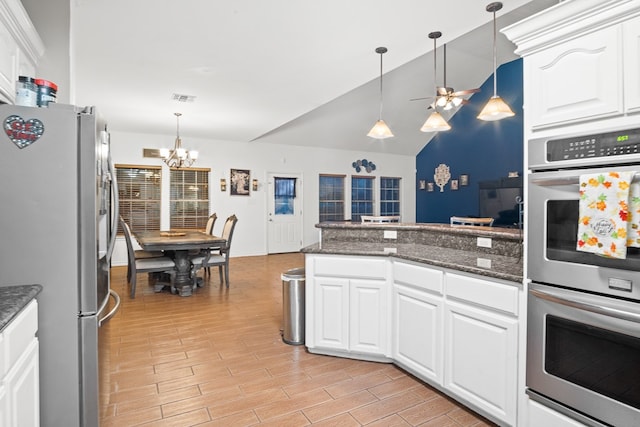 kitchen featuring light hardwood / wood-style floors, white cabinetry, pendant lighting, and appliances with stainless steel finishes