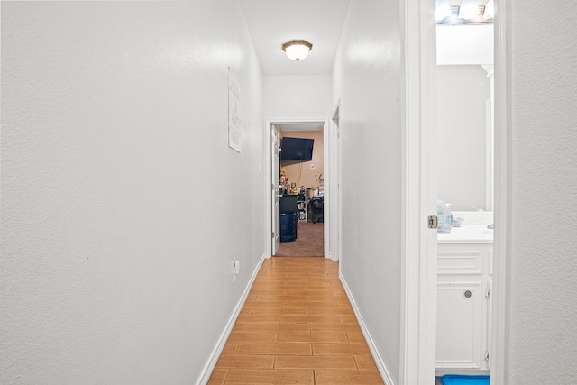 hallway with light hardwood / wood-style flooring