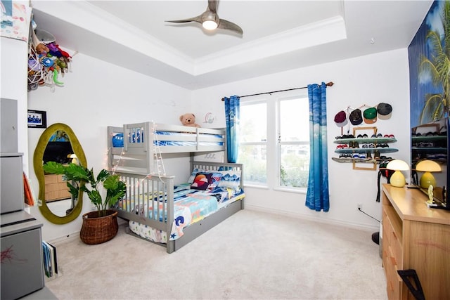 15854 El Soccorro, Corpus Christi, TX 78418 - carpeted bedroom featuring a tray ceiling, ornamental molding, and a ceiling fan