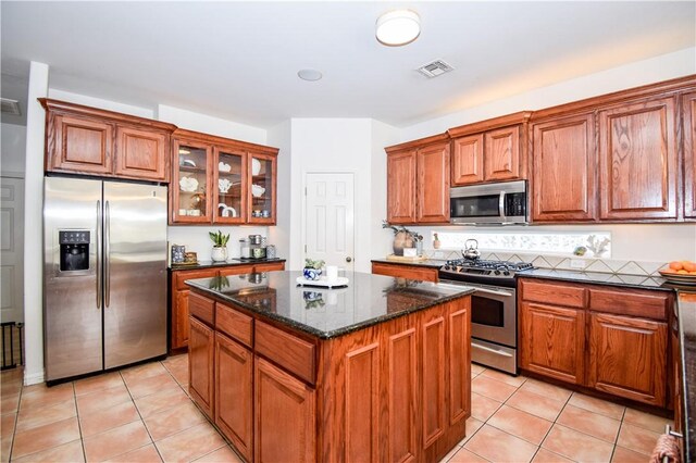 15854 El Soccorro, Corpus Christi, TX 78418 - kitchen featuring stainless steel appliances, a kitchen island, and brown cabinets