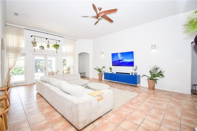 15854 El Soccorro, Corpus Christi, TX 78418 - living room with arched walkways, light tile patterned flooring, and a ceiling fan