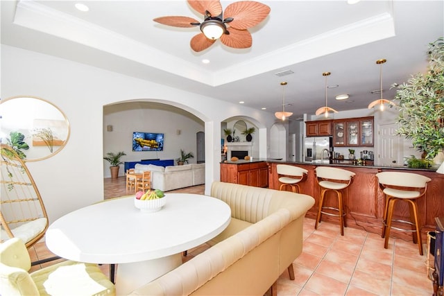 15854 El Soccorro, Corpus Christi, TX 78418 - dining space with a tray ceiling, arched walkways, ceiling fan, recessed lighting, and light tile patterned floors