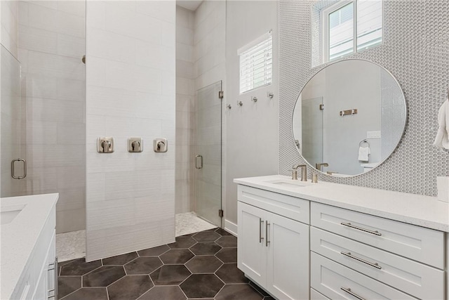 full bathroom with a shower stall, tile patterned floors, and vanity