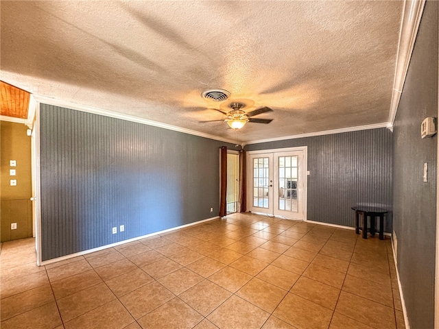 tiled empty room with ceiling fan, a textured ceiling, french doors, and ornamental molding