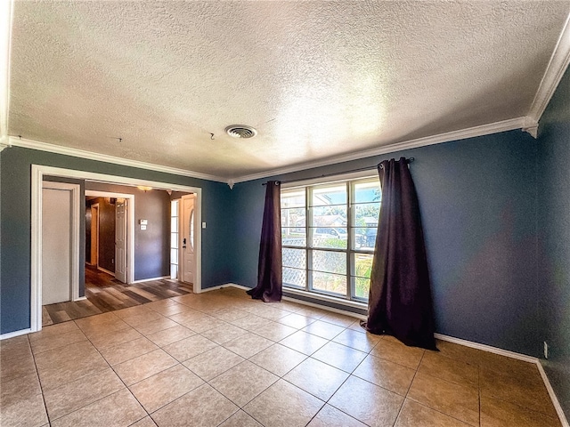 unfurnished room with tile patterned flooring, a textured ceiling, and crown molding