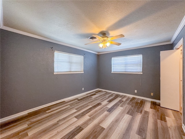 empty room featuring ceiling fan, a textured ceiling, crown molding, and light hardwood / wood-style flooring