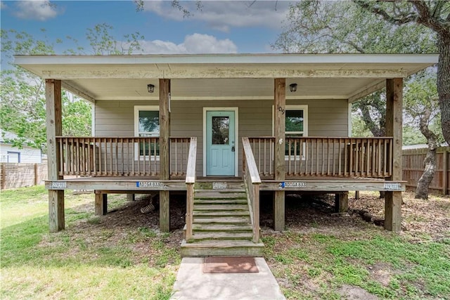 view of front of property with fence and a porch