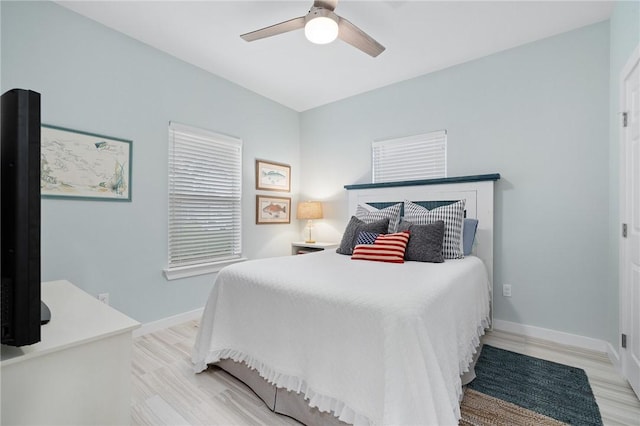 bedroom with light wood-type flooring and ceiling fan