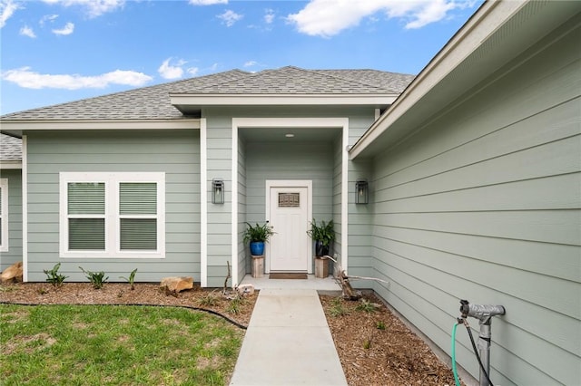 view of exterior entry featuring a yard