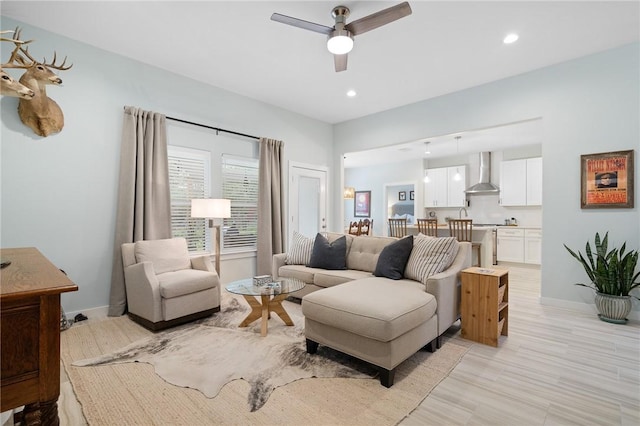 living room with ceiling fan and light hardwood / wood-style floors