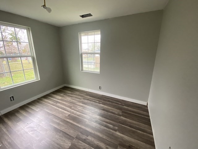 spare room with dark wood-type flooring