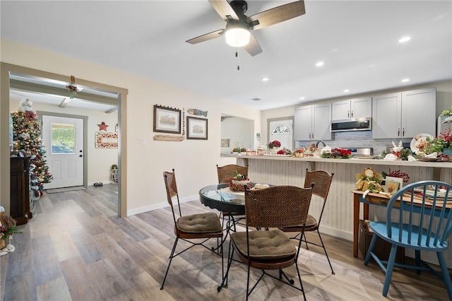 dining area featuring ceiling fan and light wood-type flooring