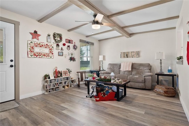 living room with beam ceiling, hardwood / wood-style flooring, and ceiling fan