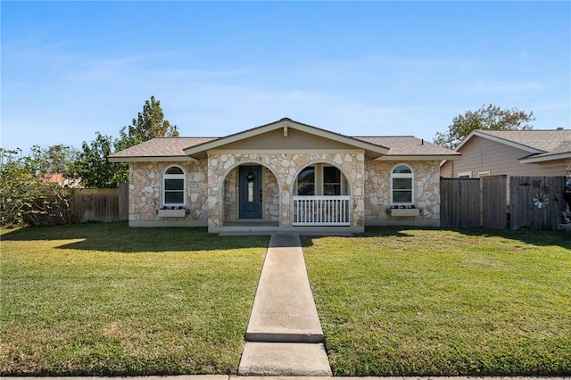 ranch-style home with covered porch and a front yard