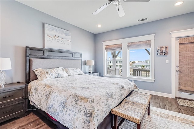 bedroom with dark hardwood / wood-style flooring and ceiling fan