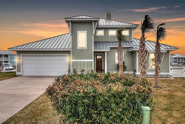 view of front of house featuring a garage and a yard