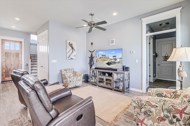 living room with wood-type flooring and ceiling fan