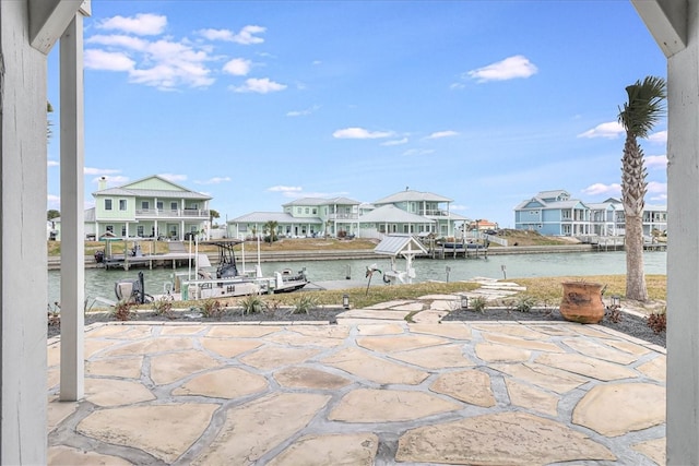 view of patio featuring a water view and a boat dock