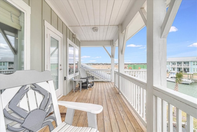 wooden terrace featuring a water view