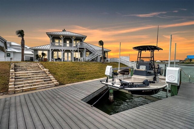 1041 Fiji Dr, Rockport, TX 78382 - dock featuring boat lift, stairway, a lawn, and a water view