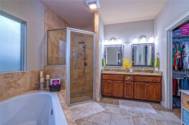 4522 Big Cyprus, Corpus Christi, TX 78410 - bathroom featuring a walk in closet, a sink, double vanity, a shower stall, and a bath