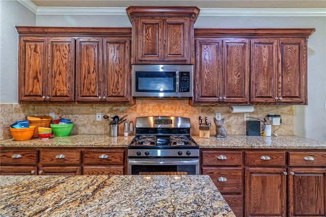 4522 Big Cyprus, Corpus Christi, TX 78410 - kitchen featuring light stone counters, ornamental molding, backsplash, and stainless steel appliances