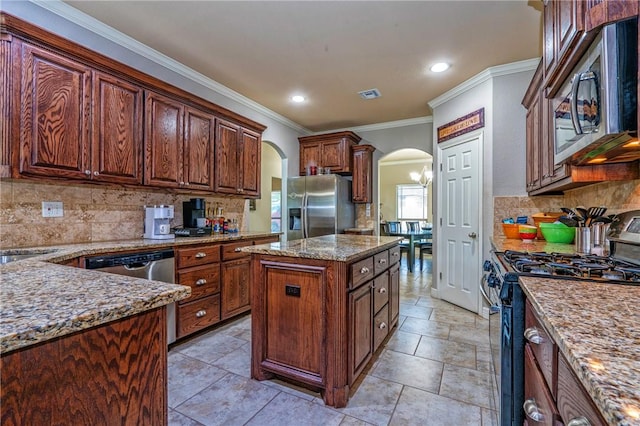 4522 Big Cyprus, Corpus Christi, TX 78410 - kitchen featuring appliances with stainless steel finishes, ornamental molding, backsplash, and arched walkways