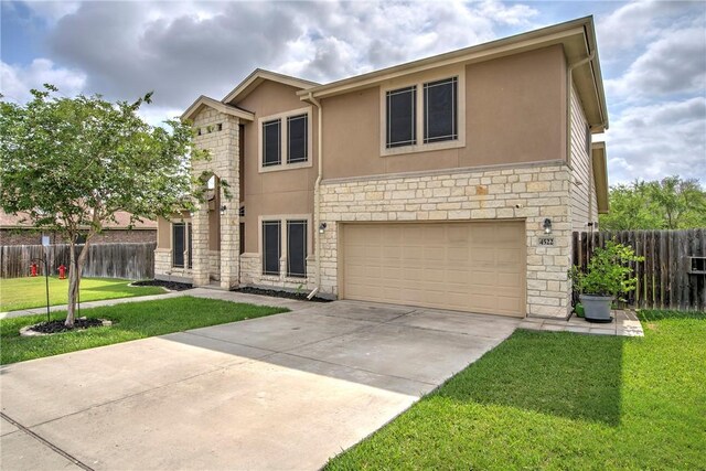 4522 Big Cyprus, Corpus Christi, TX 78410 - traditional home featuring a garage, a front lawn, stone siding, stucco siding, and concrete driveway
