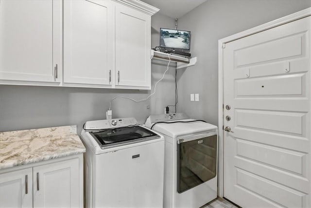 laundry room with cabinet space and separate washer and dryer