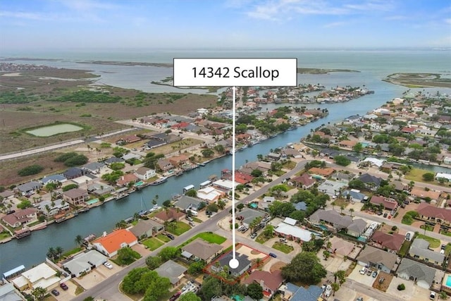 aerial view of property and surrounding area with nearby suburban area and a nearby body of water