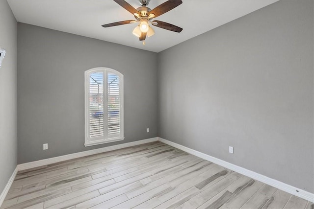 unfurnished room with light wood-style floors, baseboards, and a ceiling fan