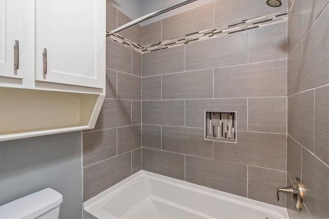 bathroom with toilet and bathtub / shower combination