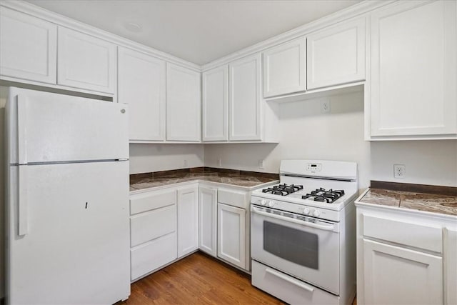 330 Ohio Ave, Corpus Christi, TX 78404 - kitchen with white appliances, white cabinetry, and wood finished floors