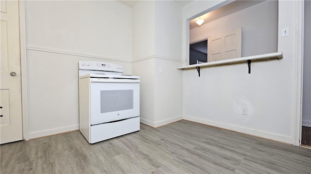 kitchen featuring white electric range oven and light wood-type flooring