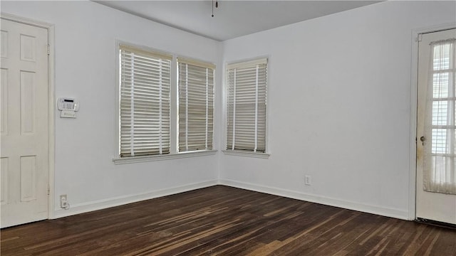 spare room featuring dark wood-type flooring