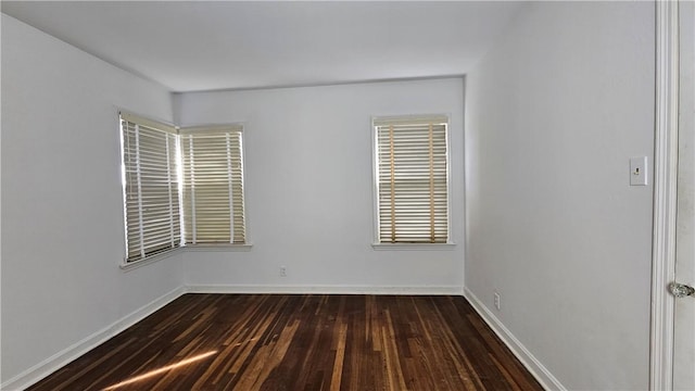 unfurnished room featuring dark hardwood / wood-style flooring