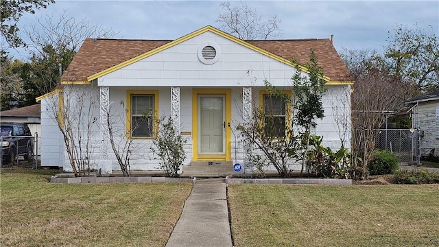 bungalow-style home featuring a front yard