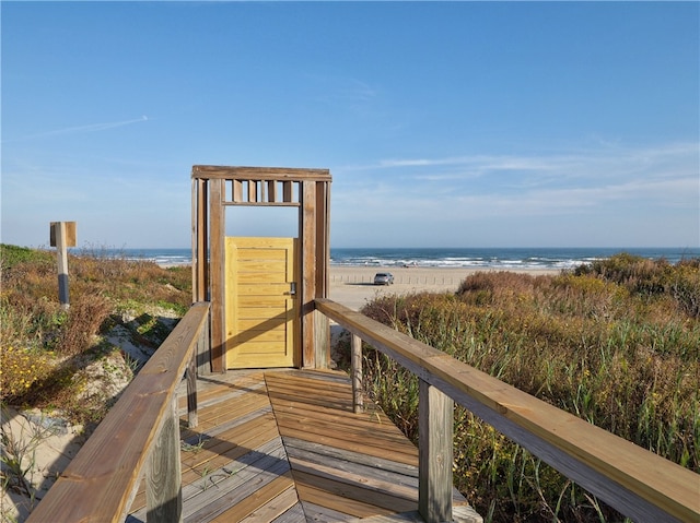 view of property's community with a beach view and a water view