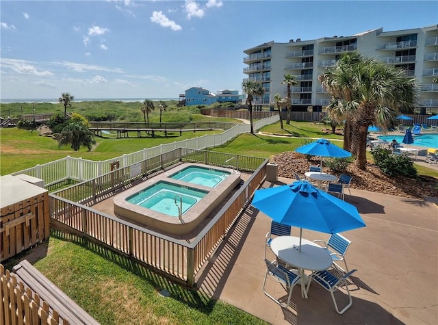 800 Sandcastle Dr Unit 129, Port Aransas, TX 78373 - view of pool with an in-ground hot tub and a patio
